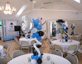 Bow tie themed balloon centerpiece with colorful latex balloons, curly Qs, and mylar heart topper